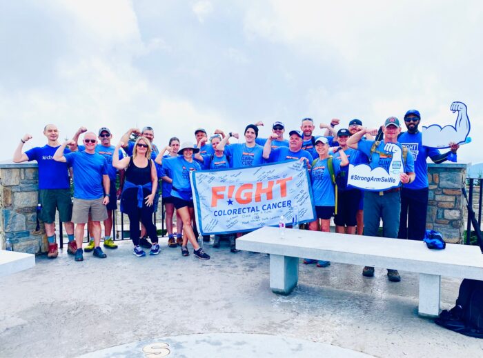 Colon Cancer and Pushing Boundaries Sarah Broadus and Fight CRC Climb for a Cure Group with Flag