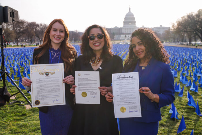 Advocacy Victories in 2022 Molly McDonnell, Anjee Davis, Erin Darbouze in front of Capitol United in Blue Call-on Congress
