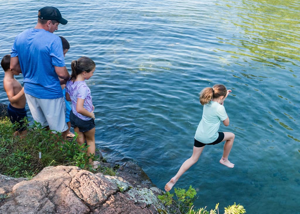 New York Climb Girl jumping into the lake. 