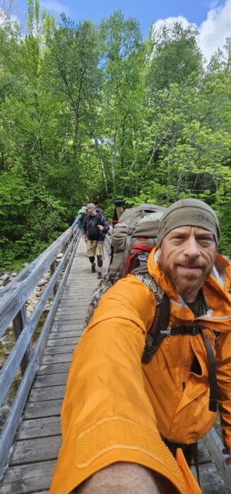 Andy and his two friends crossing a bridge at Pemi Loop Trail
